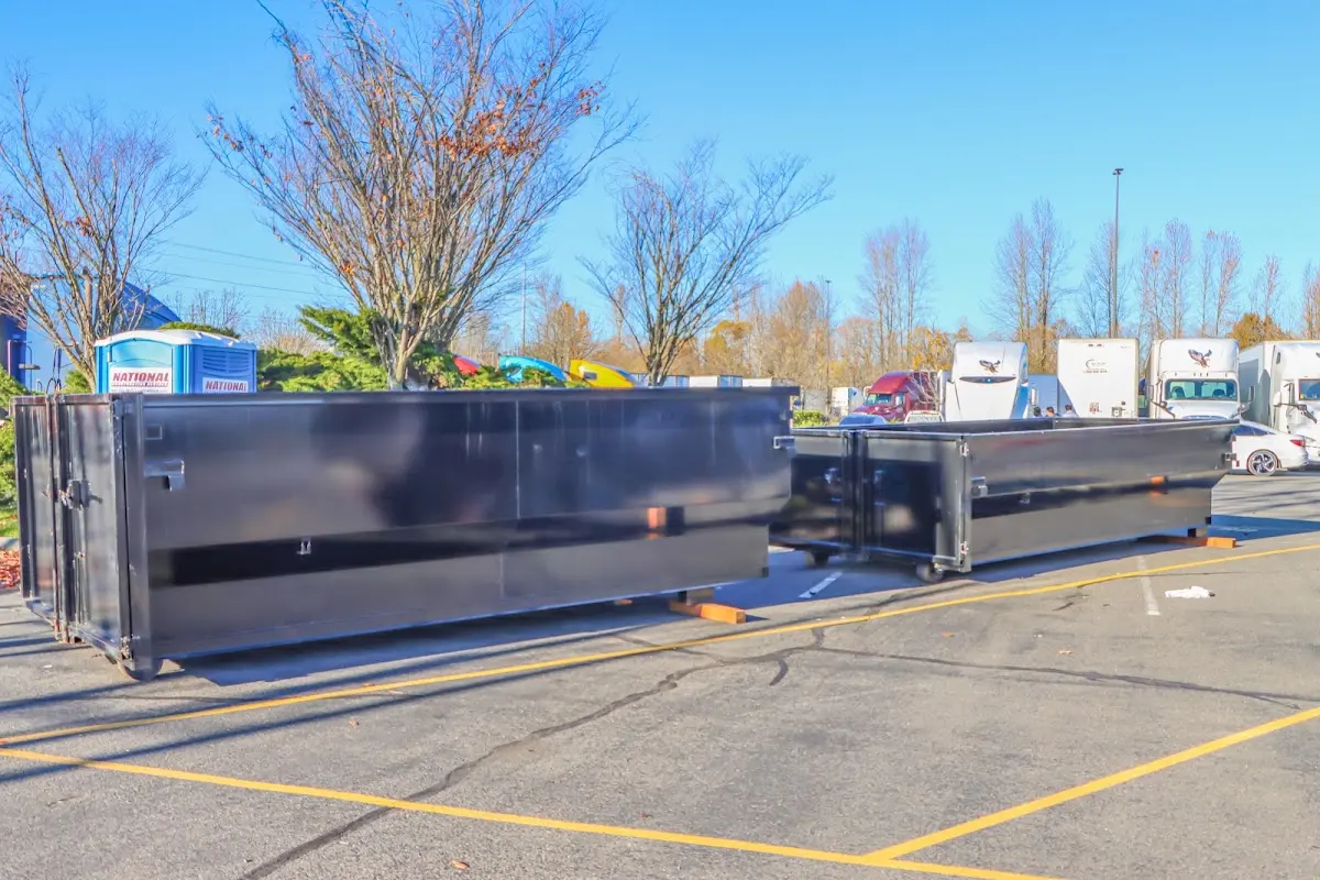 Professional dumpster rental service with roll-off container on residential driveway in Ledyard